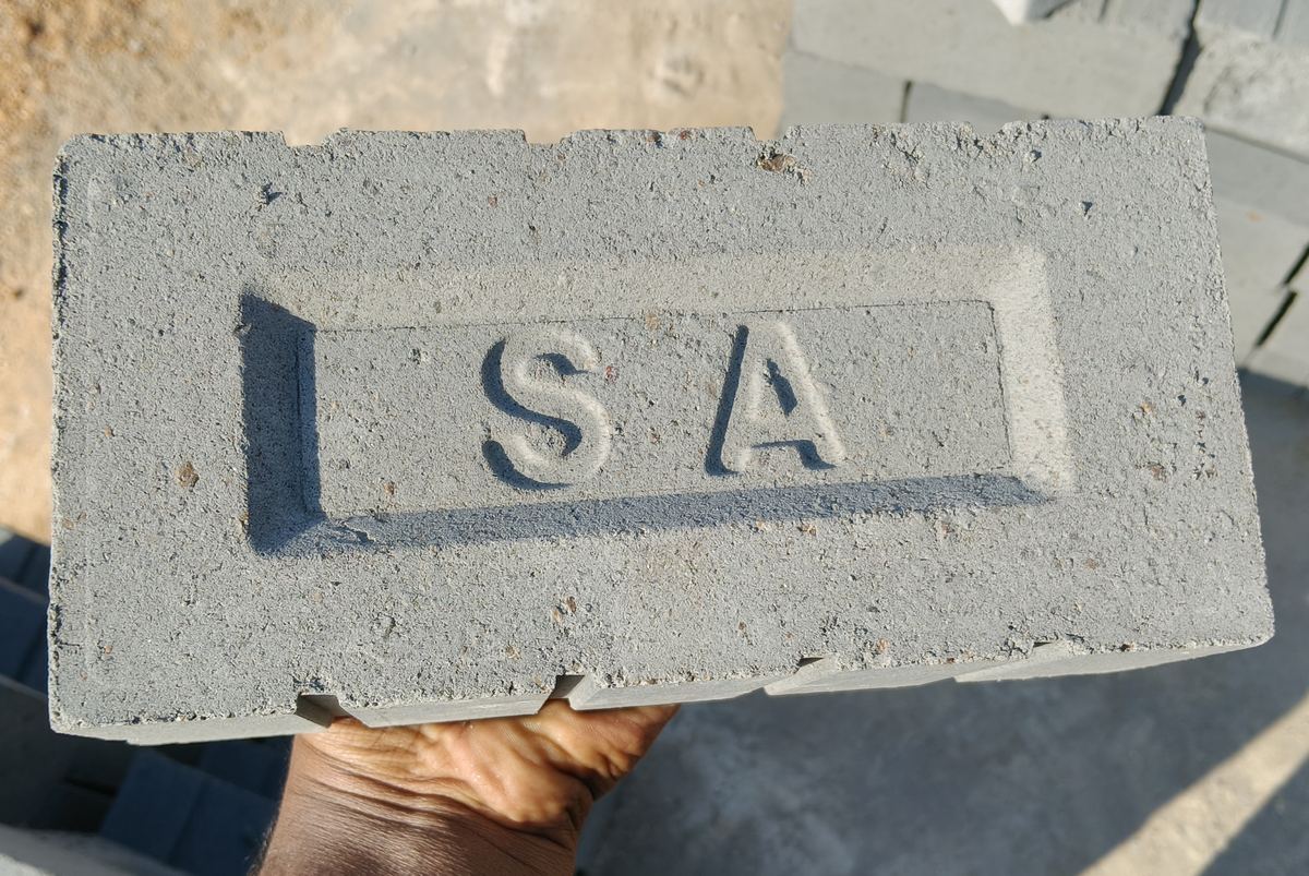 Single brick held up showing SA stamp